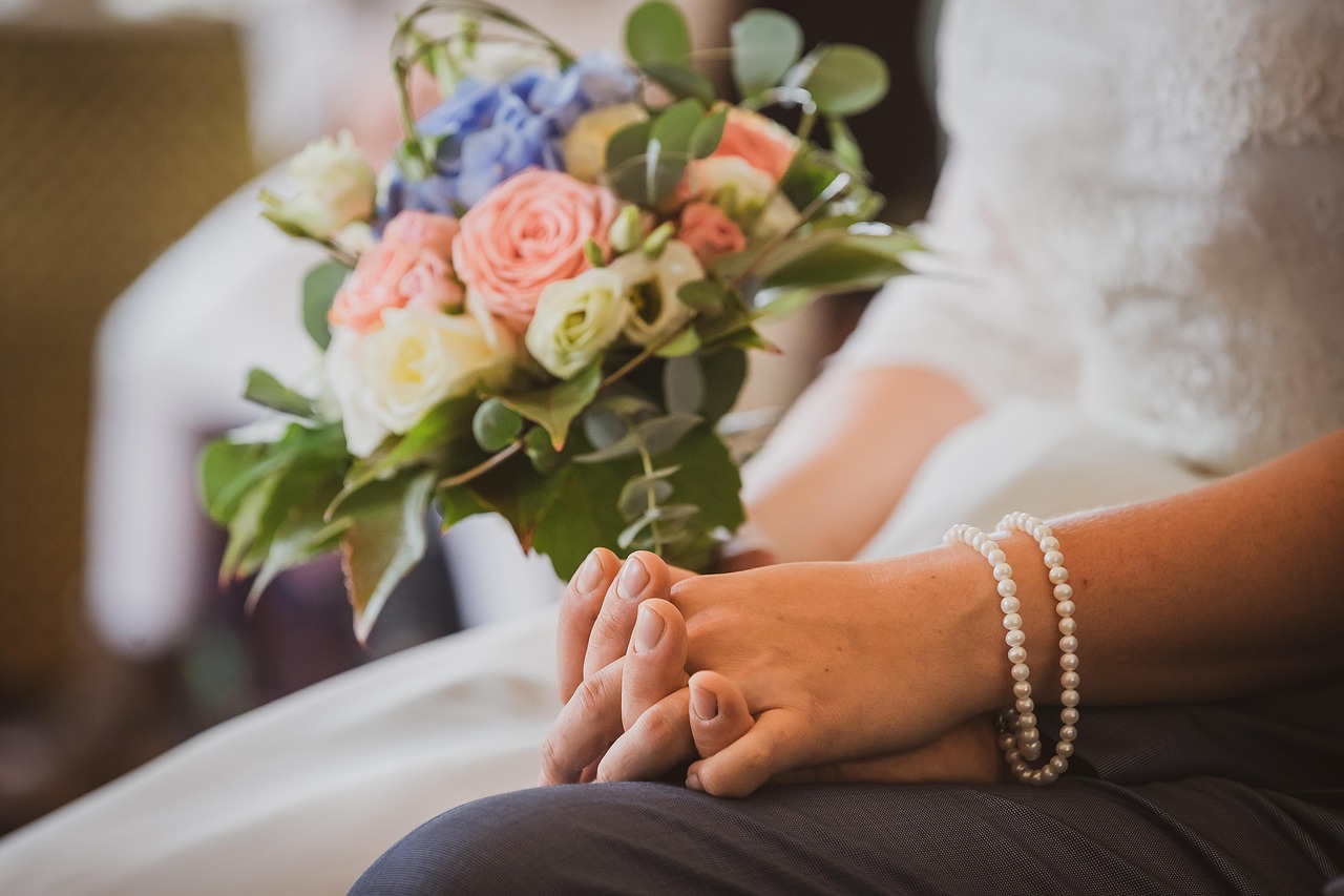 A bride's hands resting on her bouquet